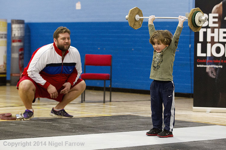 WEIGHTLIFTING-A weightlifting fan practices during a break at the 2014 English Championships in Smethwick, Great Britain